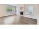 Bright living room with ample natural light, featuring a fireplace and modern gray-toned wood flooring at 20861 E 40Th Ave, Denver, CO 80249