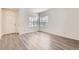 Bright living room featuring wood-style flooring, natural light from two windows, and neutral paint at 20861 E 40Th Ave, Denver, CO 80249