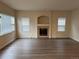 Bright living room featuring a decorative fireplace, large windows, and modern laminate flooring at 20861 E 40Th Ave, Denver, CO 80249