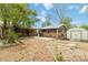 View of the backyard featuring a detached garage and storage shed at 11433 Carlile St, Northglenn, CO 80233