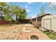View of the backyard featuring a detached garage, storage shed, and a fire pit at 11433 Carlile St, Northglenn, CO 80233