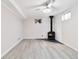 Finished basement with a wood-burning stove with a decorative white brick wall and new flooring at 11433 Carlile St, Northglenn, CO 80233
