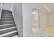 Stairs leading to a finished basement featuring light gray walls and light wood-look floors at 11433 Carlile St, Northglenn, CO 80233