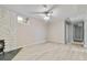 Finished basement featuring a ceiling fan, wood-look floors, and white brick accent wall at 11433 Carlile St, Northglenn, CO 80233