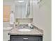 Bathroom featuring a gray vanity with granite countertops, mosaic backsplash, and a wall-mounted mirror at 11433 Carlile St, Northglenn, CO 80233