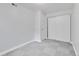 Bedroom with neutral walls, closet with sliding doors, wood-look floors, and white trim at 11433 Carlile St, Northglenn, CO 80233