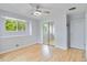 Light-filled bedroom with wood floors, ceiling fan, and view of yard at 11433 Carlile St, Northglenn, CO 80233
