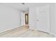 Bedroom showcasing a closet, neutral paint, wood-look flooring, and an adjoining room at 11433 Carlile St, Northglenn, CO 80233