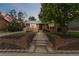 Charming brick home with manicured front yard and decorative landscaping elements at dusk at 11433 Carlile St, Northglenn, CO 80233