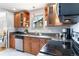 A kitchen featuring a dishwasher, granite counter, and light wood cabinets at 11433 Carlile St, Northglenn, CO 80233
