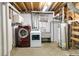 Basement laundry room featuring a washer, dryer, utility sink, and water heater at 11433 Carlile St, Northglenn, CO 80233