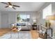 Bright living room with large window, modern decor, and hardwood floors, cozy seating area at 11433 Carlile St, Northglenn, CO 80233