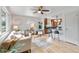 Bright living room featuring hardwood floors, ceiling fan, and open layout to the kitchen at 11433 Carlile St, Northglenn, CO 80233