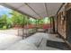 Covered patio area with wrought iron railing and access to the backyard at 11433 Carlile St, Northglenn, CO 80233