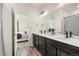 Double sink bathroom features a large mirror, modern fixtures, and wood-look floors, connected to the main bedroom at 871 E 98Th Ave # 1402, Thornton, CO 80229