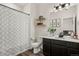 Bathroom features modern fixtures, including a shower, toilet, and vanity with a decorative mirror and ample storage at 871 E 98Th Ave # 1402, Thornton, CO 80229