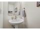 Half bath features a modern pedestal sink, a decorative mirror, and neutral decor for a clean, sophisticated look at 871 E 98Th Ave # 1402, Thornton, CO 80229