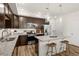 Well-equipped kitchen with granite countertops, island seating, and stainless steel appliances at 871 E 98Th Ave # 1402, Thornton, CO 80229