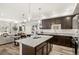 Bright, open-concept kitchen and dining area with stainless steel appliances, granite countertops, an island, and an adjacent living space at 871 E 98Th Ave # 1402, Thornton, CO 80229