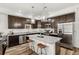 Modern kitchen features stainless steel appliances, granite countertops, an island with pendant lighting, and dark wood cabinetry at 871 E 98Th Ave # 1402, Thornton, CO 80229