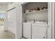 Efficient laundry area with a washer, dryer, storage shelf, and closet for all your laundry needs at 871 E 98Th Ave # 1402, Thornton, CO 80229