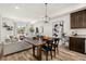 Elegant living and dining area featuring stylish decor, modern lighting, and comfortable furnishings at 871 E 98Th Ave # 1402, Thornton, CO 80229