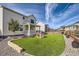 Artificial turf backyard with playhouse and rock border at 1173 Williams Loop, Elizabeth, CO 80107