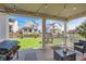 Covered patio with backyard views, string lights, and grill at 1173 Williams Loop, Elizabeth, CO 80107
