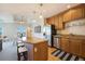 Kitchen featuring stainless steel appliances, wood cabinets, granite countertops, and breakfast bar at 1827 N Grant St # 1104, Denver, CO 80203