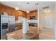 Kitchen island with granite countertop and stainless steel appliances and wood cabinets at 1827 N Grant St # 1104, Denver, CO 80203
