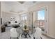 Living room with neutral tones and glass table with chairs, leading to a balcony with city views at 1827 N Grant St # 1104, Denver, CO 80203