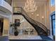 Elegant lobby with a grand chandelier, curved staircase, and tiled floors and seating at 1827 N Grant St # 1104, Denver, CO 80203