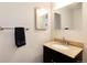 Elegant bathroom featuring granite countertops, updated fixtures, and stylish mirror at 9661 W Chatfield Ave # B, Littleton, CO 80128