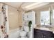Functional bathroom featuring a shower-tub combo and vanity with granite countertop at 9661 W Chatfield Ave # B, Littleton, CO 80128