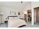 Cozy bedroom featuring neutral tones and a view into an adjacent bathroom at 9661 W Chatfield Ave # B, Littleton, CO 80128