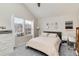 Bright bedroom featuring a large window for natural light and neutral tones at 9661 W Chatfield Ave # B, Littleton, CO 80128
