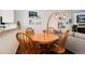 Cozy dining area featuring hardwood table, chairs, modern lighting and decor at 9661 W Chatfield Ave # B, Littleton, CO 80128