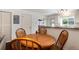 Cozy dining area with hardwood table, chairs and a view to the kitchen bar area at 9661 W Chatfield Ave # B, Littleton, CO 80128