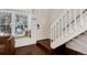 Welcoming entryway with a cozy window seat, staircase and lovely hardwood floors at 9661 W Chatfield Ave # B, Littleton, CO 80128