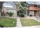 Charming home with well-manicured lawn, mature trees and a stone facade at 9661 W Chatfield Ave # B, Littleton, CO 80128