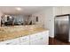 Stylish kitchen with granite countertops, stainless appliances and access to the living room at 9661 W Chatfield Ave # B, Littleton, CO 80128