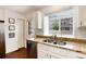 Bright kitchen featuring granite countertops, stainless steel appliances, and ample natural light at 9661 W Chatfield Ave # B, Littleton, CO 80128