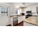 Well-lit kitchen with granite countertops, stainless steel appliances and view to the exterior at 9661 W Chatfield Ave # B, Littleton, CO 80128