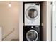 Convenient laundry area with stacked washer and dryer in a hallway closet at 9661 W Chatfield Ave # B, Littleton, CO 80128