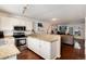 Living room with hardwood floors, modern kitchen, granite countertops and stainless steel appliances at 9661 W Chatfield Ave # B, Littleton, CO 80128