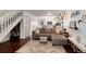Inviting living room features stairs to the upper level and seamlessly flows into an open kitchen at 9661 W Chatfield Ave # B, Littleton, CO 80128