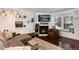 Comfortable living room featuring a fireplace, large tv, and inviting window seat with shelves at 9661 W Chatfield Ave # B, Littleton, CO 80128