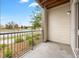 This outdoor balcony has iron railings and a view of the yard and city at 981 S Sable Blvd # 107, Aurora, CO 80012