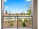 A cozy balcony with iron railings overlooking a landscaped yard and a vibrant cityscape at 981 S Sable Blvd # 107, Aurora, CO 80012