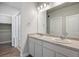 Well-lit bathroom with a double sink vanity, a large mirror and a glass-enclosed shower at 981 S Sable Blvd # 107, Aurora, CO 80012